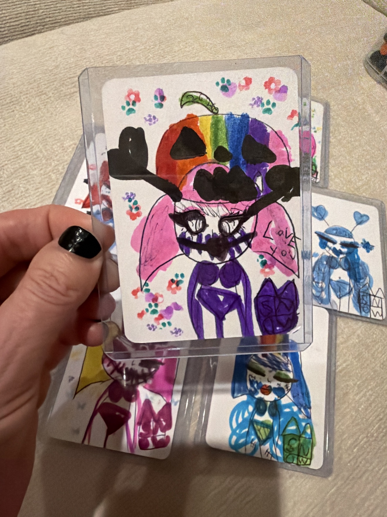 Rainbow pumpkin-head character with a purple body and the words Love You